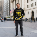 Man wearing Crypt Apparel black hoodie Golden Cross Bull Market signal design